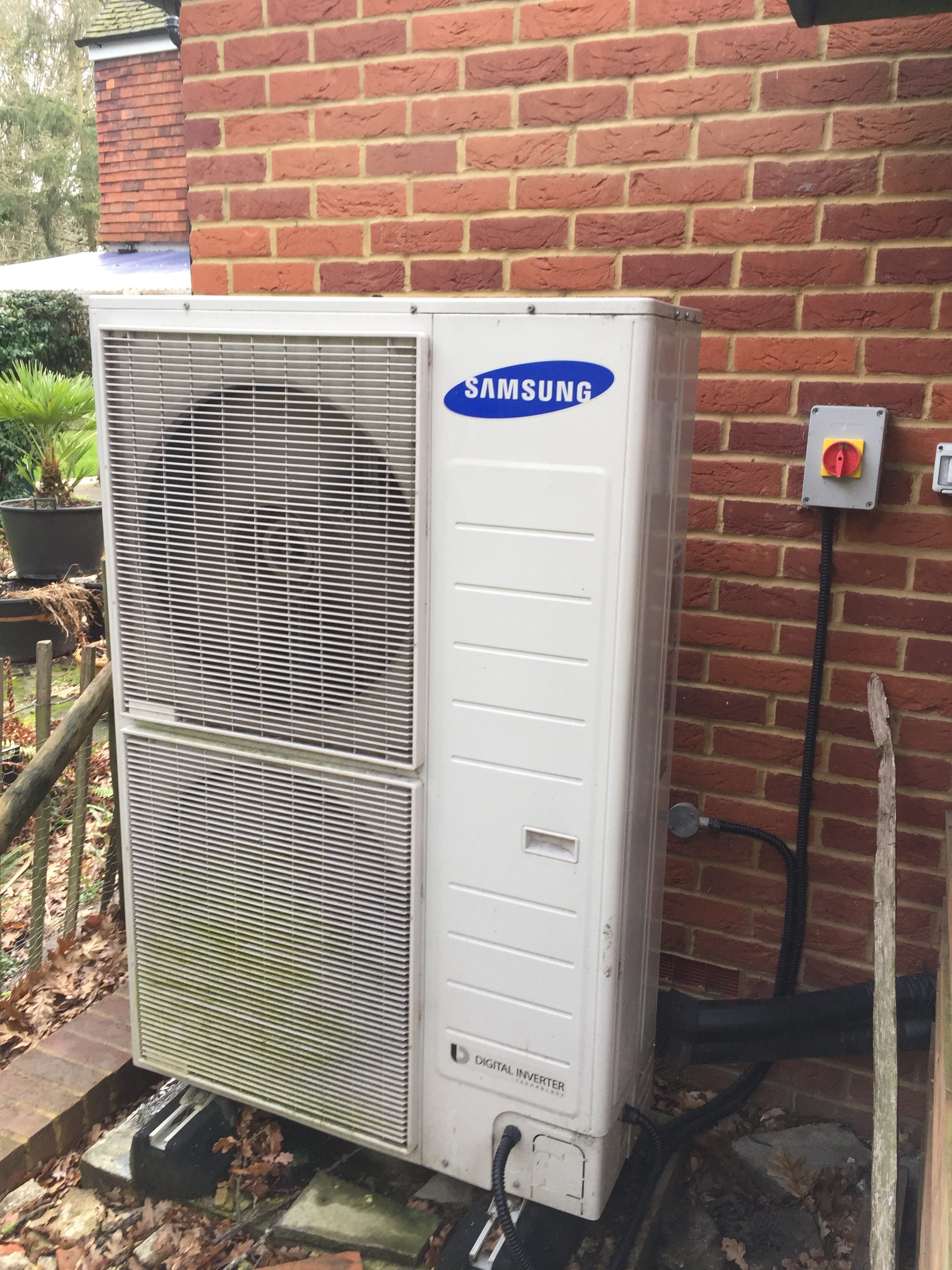 air source heat pump next to house Air Source Heat Pump Servicing